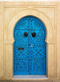 Blue aged door with ornament from Sidi Bou Said in Tunisia