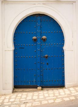 Blue door in Andalusian style from Sidi Bou Said in Tunisia