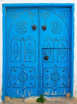 Blue wooden aged door with arch from Sidi Bou Said in Tunisia