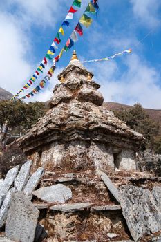 Buddhism stupa or chorten with prayer flags in Himalayas. travel to Nepal. relegion and culture