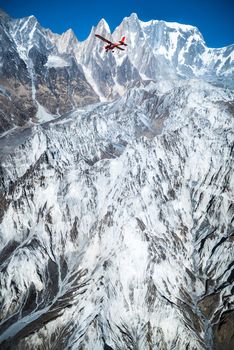 Flying on the plane over Machapuchare or fishtail Mountain in Himalayas. Travel to Nepal 