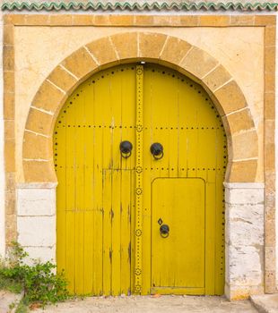 Yellow gates with door and ornament from Sidi Bou Said. Tunisian culture