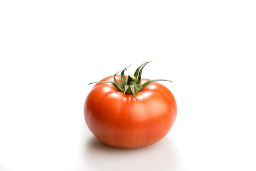 One realistic looking fresh red tomato isolated in a white background side view