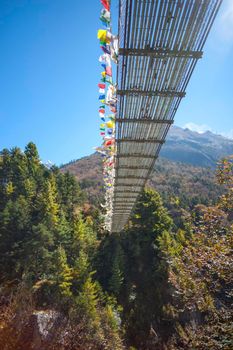 Suspension bridge over the river in Himalayas. Everest base camp trek in Nepal 