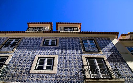 Old colorful and beautiful facades with vintage streetlight in Lisbon streets in Spring.