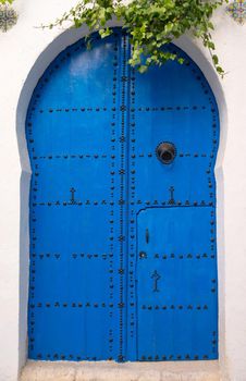 Blue wooden door with arch from Sidi Bou Said in Tunisia