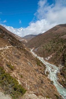 Lhotse summit, trail and river in the Himalayas. Everest base camp trek in Nepal