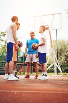 Young basketball players prepare to play in a urban place.