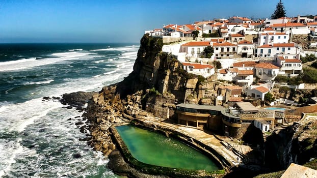Beautiful Azenhas do Mar village perspective with white houses and natural swimming pool in Portugal
