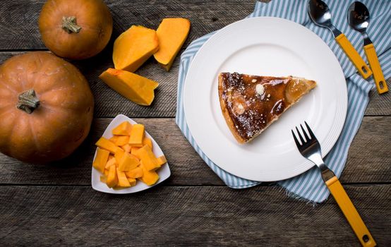 Rustic style Pumpkin slices and piece of pie. food photo