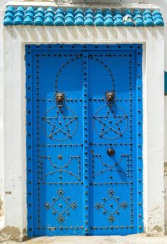 Aged Blue door in Andalusian style from Sidi Bou Said in Tunisia