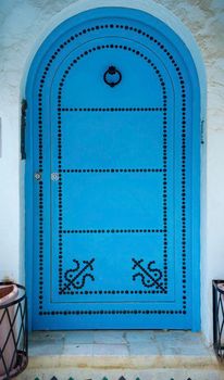 Aged Blue door in Andalusian style from Sidi Bou Said in Tunisia