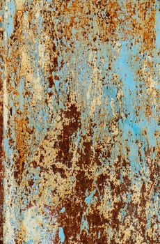 rust and damaged blue and yellow paint on metal sheet. Backgrounds and textures