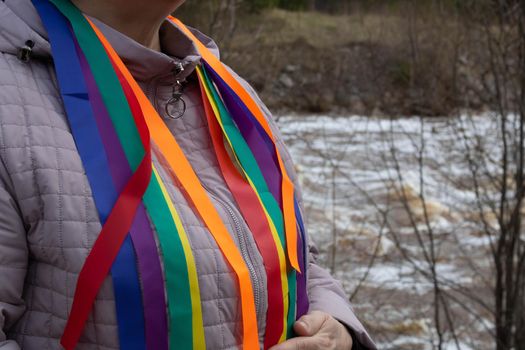 Bright rainbow ribbons hang from her shoulders .Carnival ribbons. LGBT symbol.