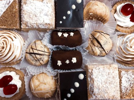 Lots of cakes beautifully stacked close-up, view from above.