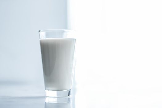 Dairy, healthy nutrition and breakfast concept - World Milk Day, full glass on marble table