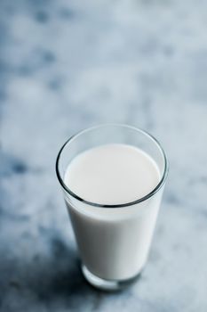 Dairy, healthy nutrition and breakfast concept - World Milk Day, full glass on marble table