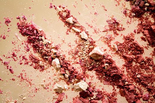 Crushed cosmetics, mineral organic eyeshadow, blush and cosmetic powder isolated on golden background, makeup and beauty banner, flatlay design.