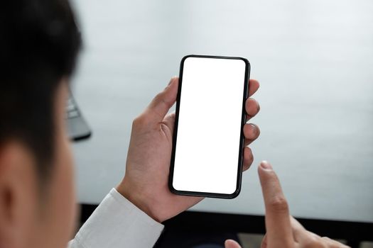 Shot of man holding blank screen mock up mobile phone