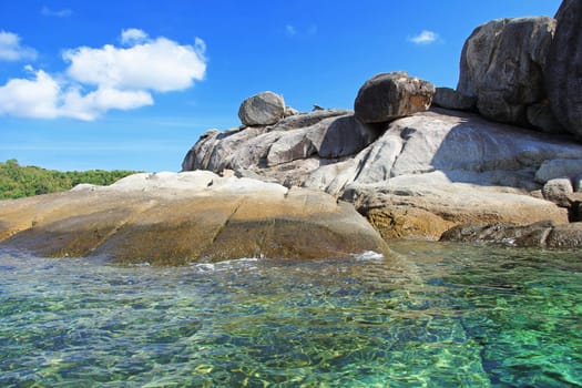 The island has a rocky beach. In areas with snorkel coral.