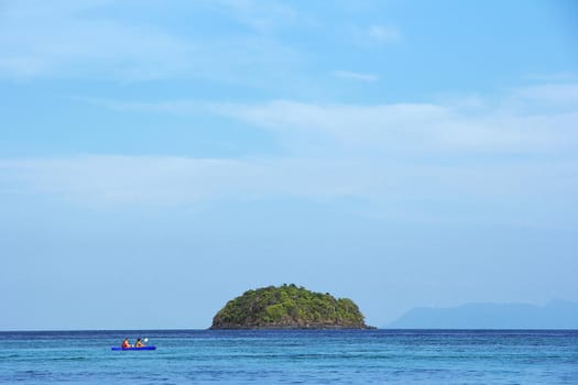 Island with blue sky as background.