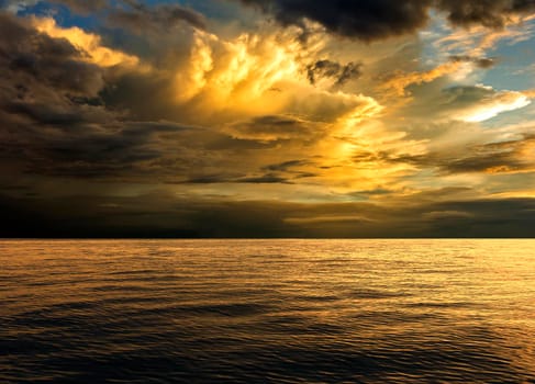 Background sea in the evening sky with golden clouds.