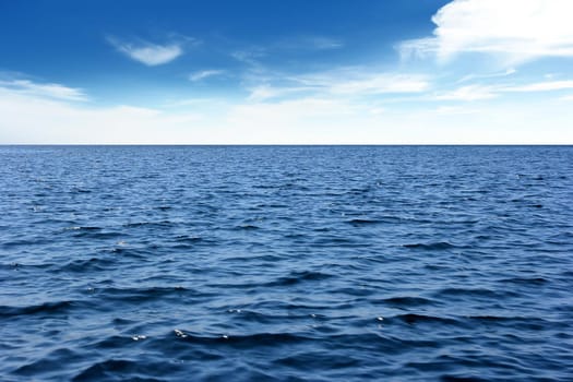 Blue sea with waves and wind. And the sky as background.