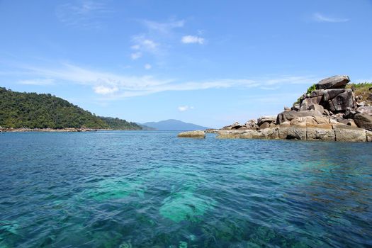 The coastal water green with sky blue coral islands.