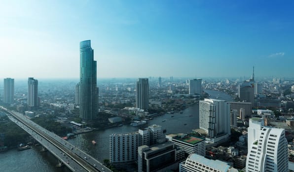 Chao Phraya river and high building sky scrapper in heart of bangkok thailand