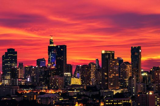 Large cities with tall buildings at night. The sky is red