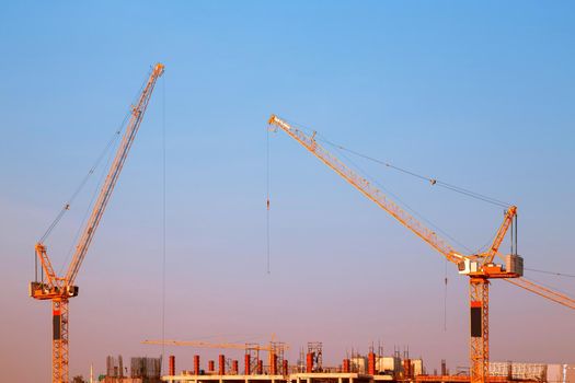Industrial construction crane during sunset