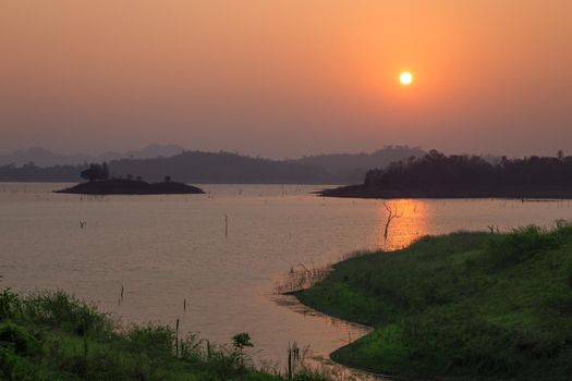 Sunset at the lake with a beautiful orange light. Pompey, Kanchanaburi, Thailand.