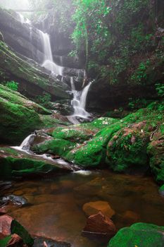 Saithip waterfall in Phu Soi Dao National Park, Thailand. A small waterfal with beautiful scenery of lush rocks and forest line