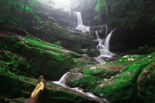 Saithip waterfall in Phu Soi Dao National Park, Thailand. A small waterfal with beautiful scenery of lush rocks and forest line