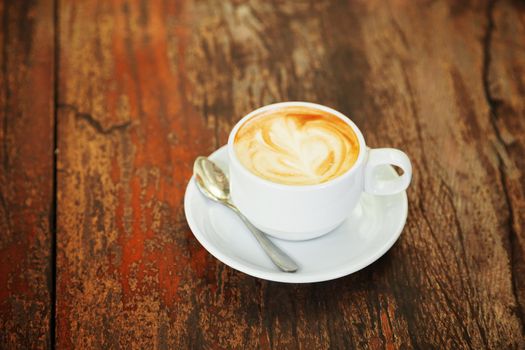 Hot art Latte Coffee in a cup on wooden table