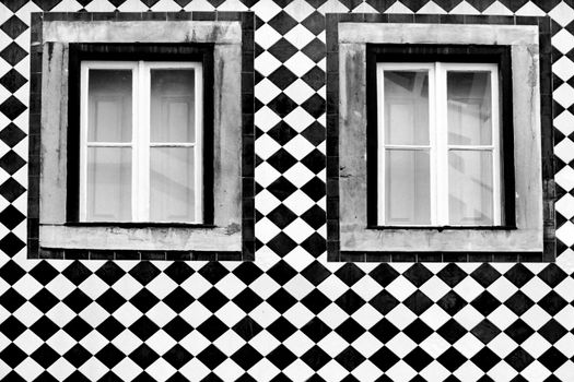Old colorful and bright typical facade in Lisbon with beautiful vintage wooden window