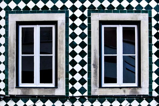 Old colorful and bright typical facade in Lisbon with beautiful vintage wooden window