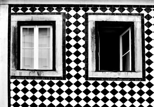 Old colorful and bright typical facade in Lisbon with beautiful vintage wooden window