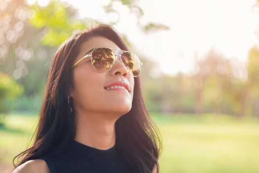 Young woman relaxing with good weather in the park.