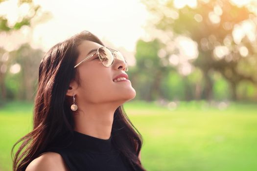 Young woman relaxing with good weather in the park.