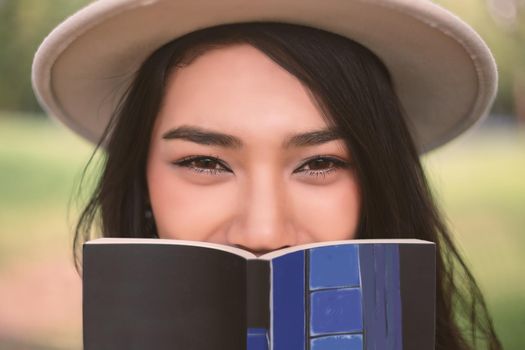 Young woman relaxing in the garden with a book.