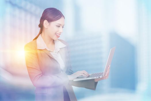 Young pretty business woman with notebook. Double exposure photo of panoramic city