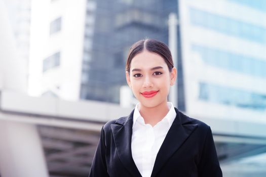 Young business woman in the big city purposefully looking away.