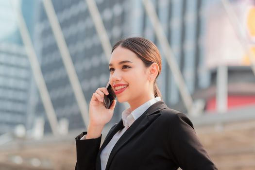 Attractive businesswoman talking on mobile phone with client.