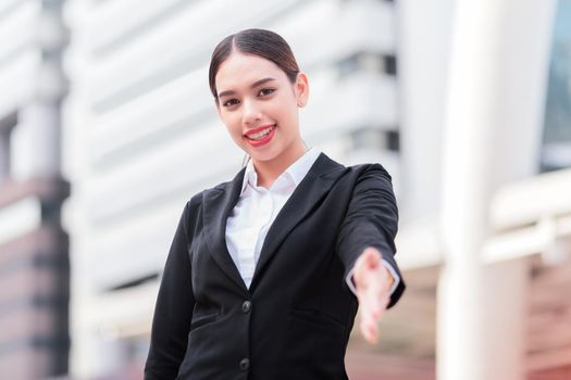 Business woman giving a hand/ handshake