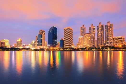 City building with water reflection in twilight