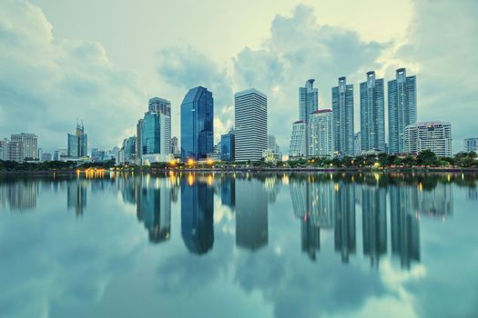 City building with water reflection in twilight