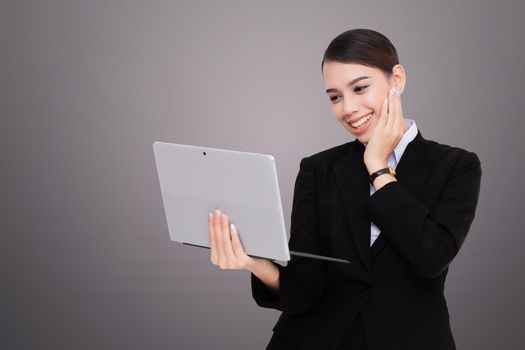 Portrait of beautiful young woman holding digital tablet