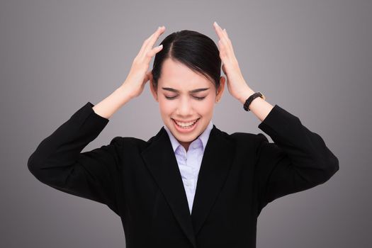 Young woman making a mistake on a gray background