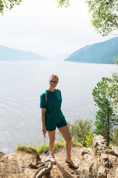 Woman on Teletskoye lake in Altai mountains, Siberia, Russia. Beauty summer day.